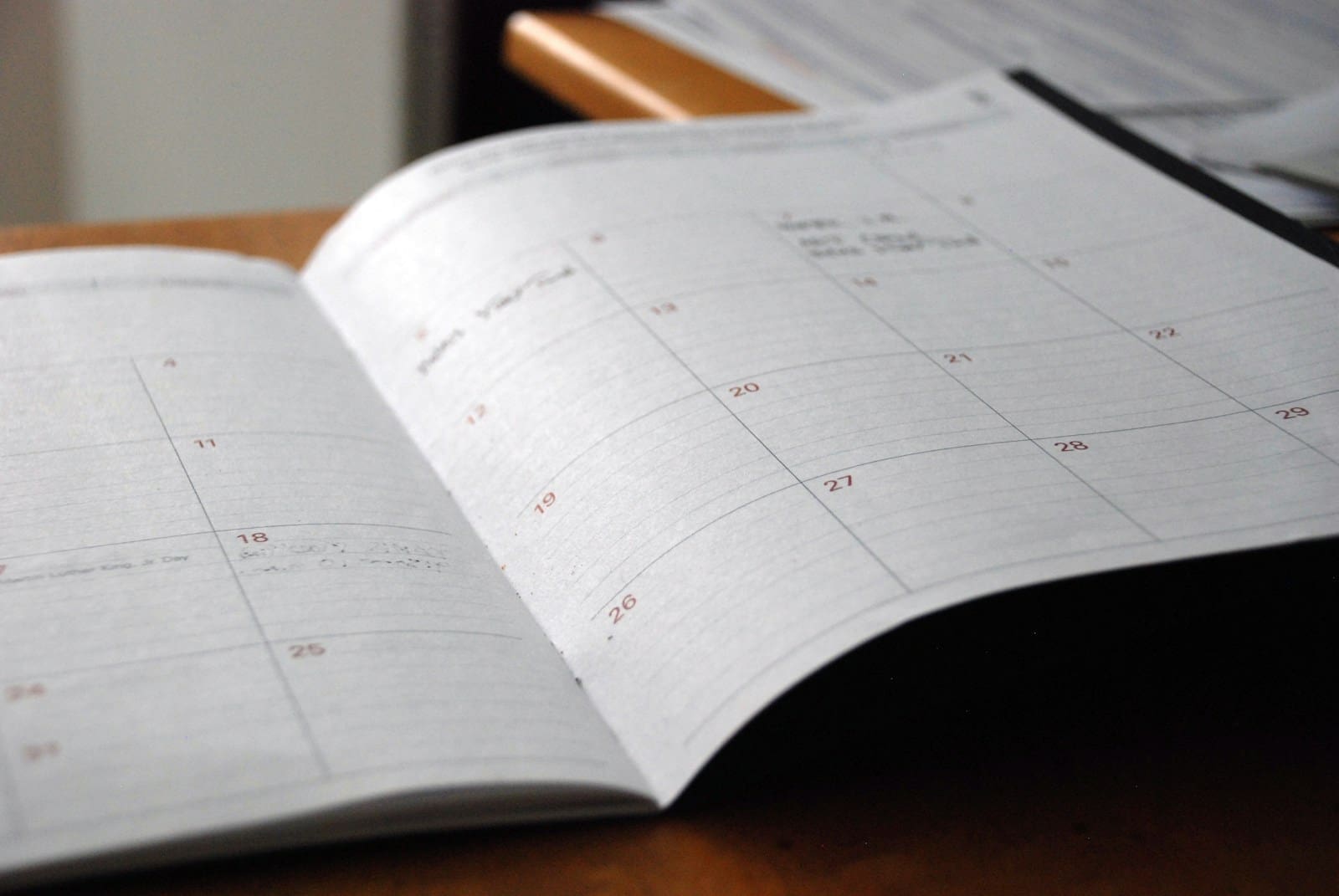 A monthly study schedule planner open on a desk, illustrating a six-month GCSE Maths study plan